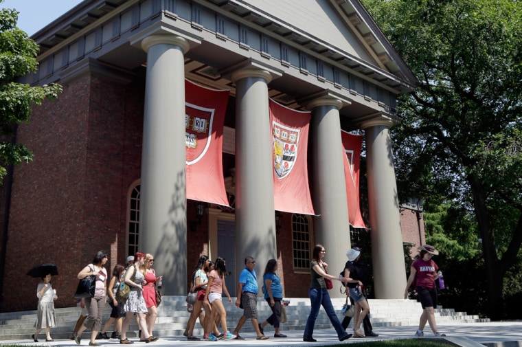 People are led on a tour on the campus of Harvard University in Cambridge, Mass.