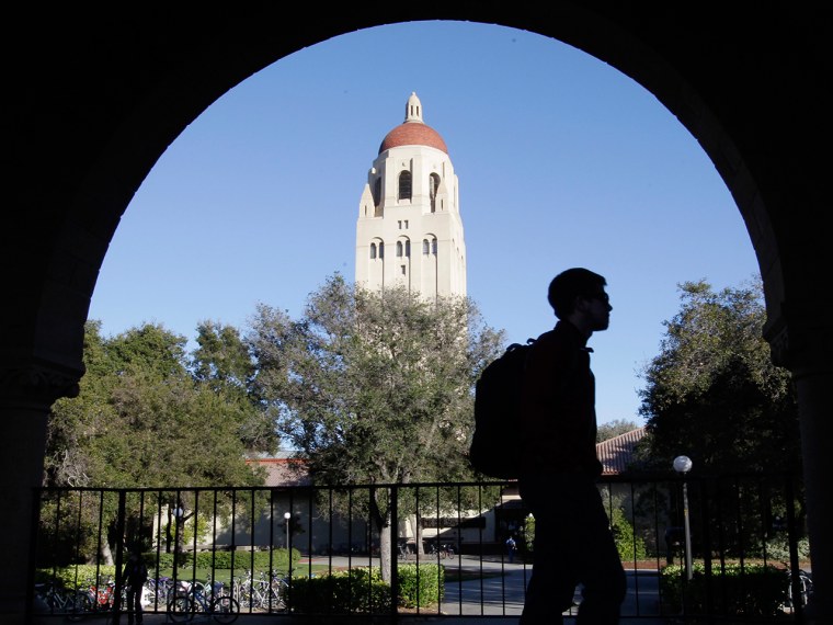 FILE - In this Feb. 15, 2012 file photo, a Stanford University student walks in front of Hoover Tower on the Stanford University campus in Palo Alto, Calif. Congressional inaction could end up costing college students an extra $5,000 on their new loans. The rate for subsidized Stafford loans is set to increase from 3.4 percent to 6.8 percent on July 1, just as millions of new college students start signing up for fall courses. The difference between the two rates adds up to $6 billion. (AP Photo/Paul Sakuma, File)