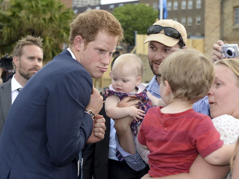 Prince Harry makes a funny face at a young child as he is greeted by a large crowd during the International Fleet Review in Sydney, Saturday, Oct. 5, ...
