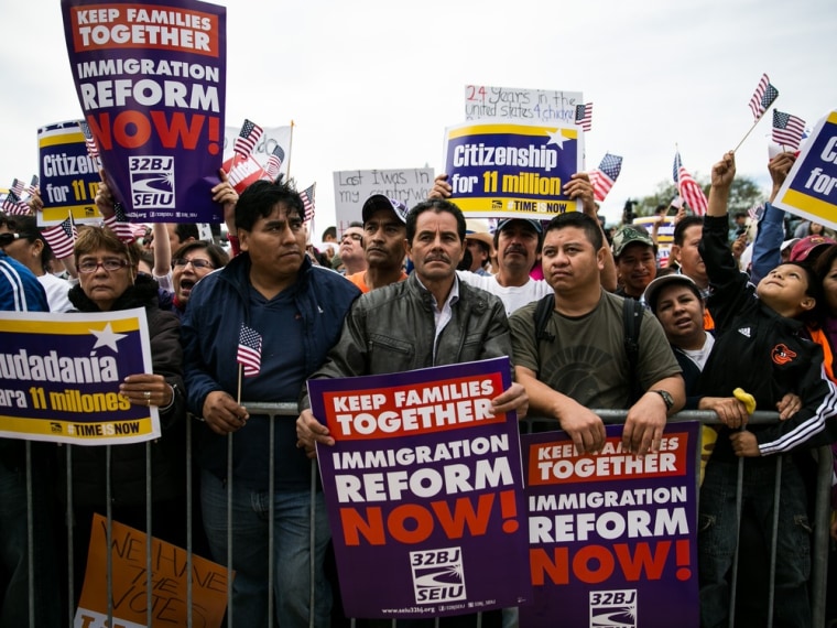 Attendees hold signs calling for immigration reform during a rally in support of immigration reform, in Washington, on October 8, 2013 in Washington, DC. Last week, House Democrats introduced their own immigration reform bill.