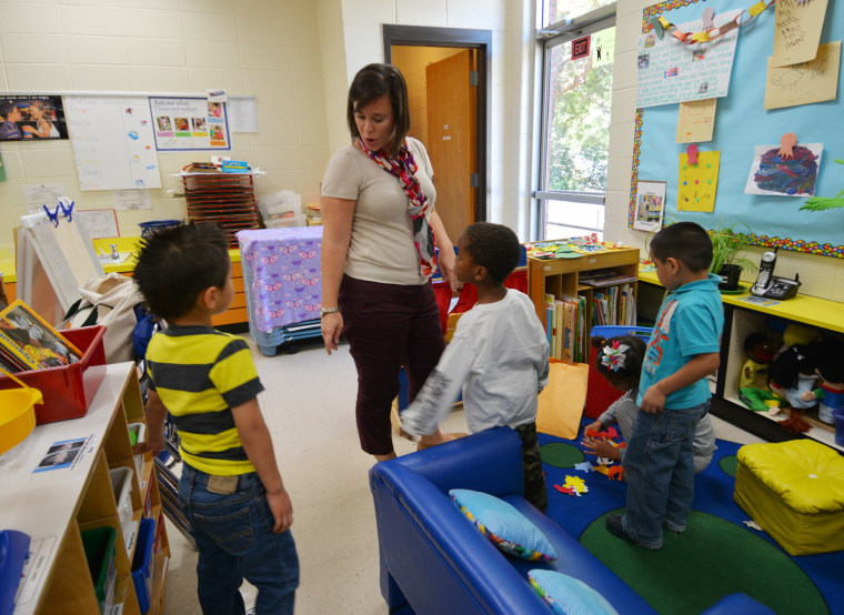 Children at the Cobb County, Ga., Head Start program play with program director Michelle Patterson. The program had been closed because of a lack of funds but reopened after a $10 million donation from philanthropists.