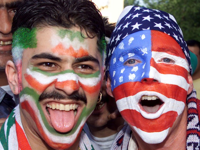 An Iranian and an American football fan shout together before their teams' game at the 1998 World Cup game in France.