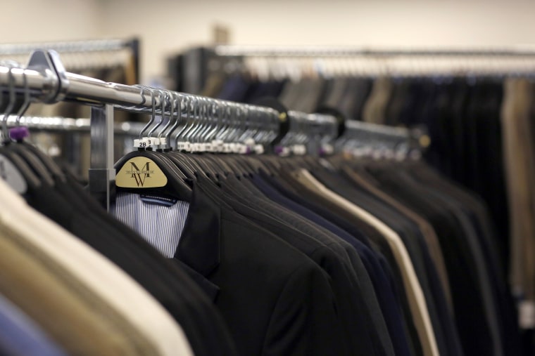 Suits hang on a rack at a Men's Wearhouse store in Pasadena, Calif. The company brushed aside a buyout offer from Jos. A. Bank Clothiers.