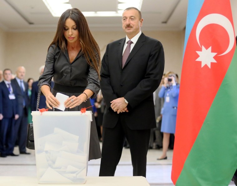 Azerbaijan's President Ilham Aliyev watches his wife Mehriban Aliyeva casting her ballot in a polling station in Baku on Wednesday.