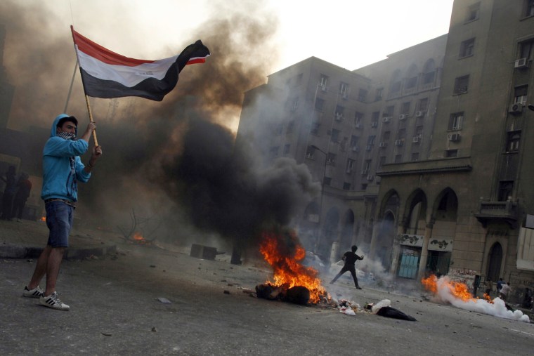 Tires burn as supporters of ousted President Mohamed Morsi clash with police in downtown Cairo on Oct. 6.