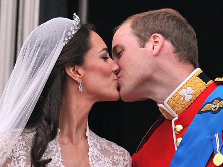 Prince William and his wife Kate Middleton, Duchess of Cambridge, kiss on the balcony of Buckingham Palace in London, following their wedding on April...