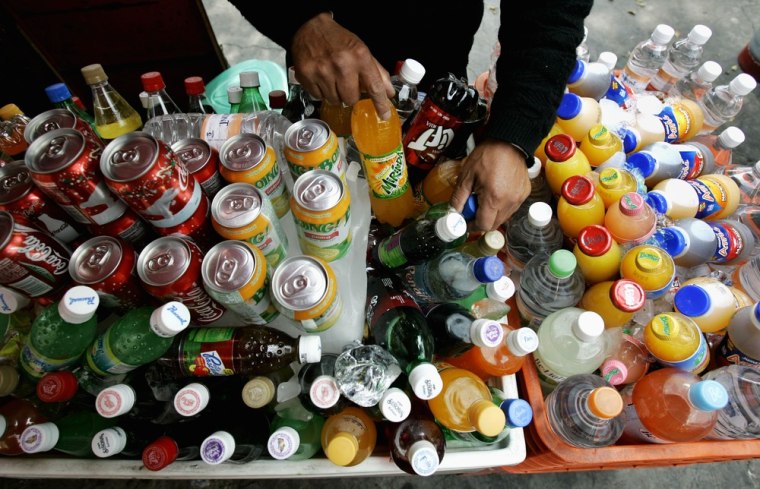 A street seller arranges soft drinks in Mexico City. Mexico's President Enrique Pena Nieto has proposed to raise millions from a soda tax.