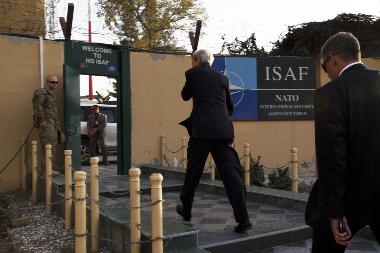 Secretary of State John Kerry, center, enters ISAF headquarters after arriving on an unannounced visit to Kabul on Friday.