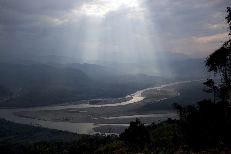 Sunlight filters through the clouds, illuminating the Apurimac river in Pichari, Peru. The river cuts through a long valley that the United Nations says yields 56 percent of Peru's coca leaves. The government says it will soon begin destroying coca crops in the region, known as the VRAE - the Valley of the Apurimac and Ene rivers.