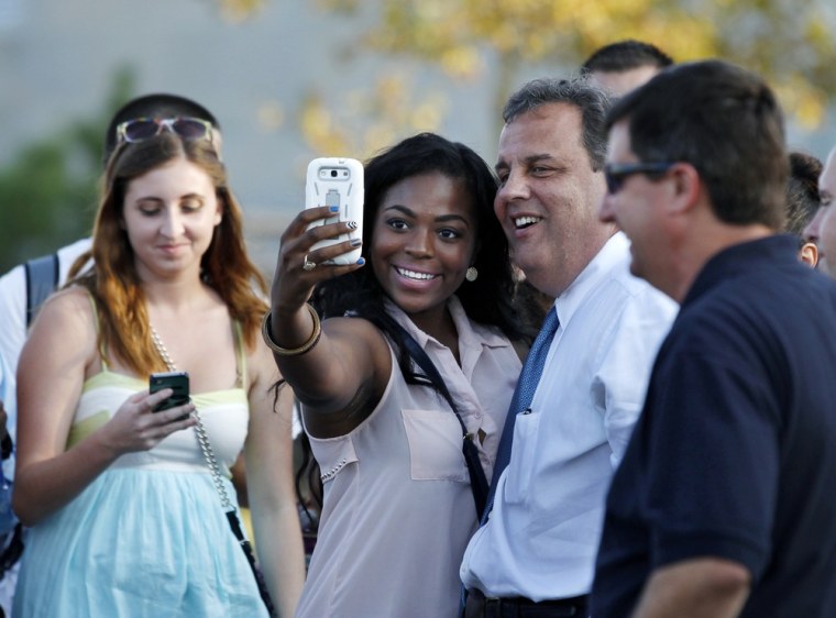 New Jersey Gov. Chris Christie has his picture taken by student Anika DeBerry at Rowan University in Glassboro, N.J., Wednesday, Oct. 2, 2013.