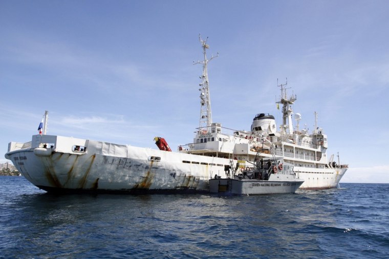 A Venezuelan Coast Guard boat sits next to the 285-foot survey ship Teknik Perdana docked near the shore in Margarita Island, Venezuela, Sunday.