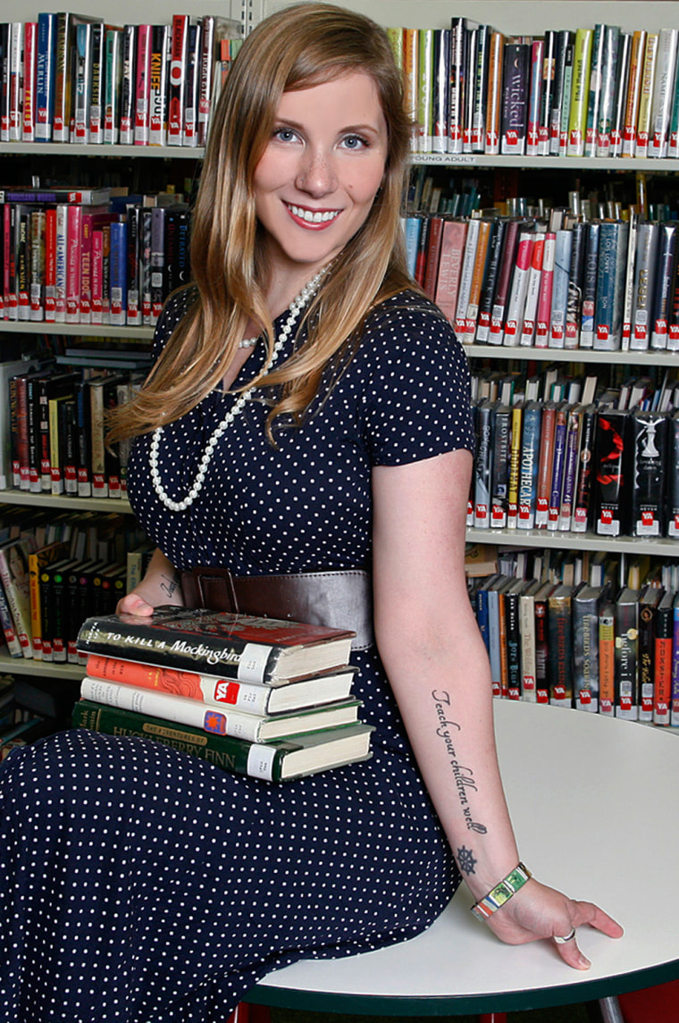 In this July 2013 photo provided by the Rhode Island Library Association, librarian Emily Grace Mehrer poses in Providence, R.I., for a photo to be used in a 2014 fundraising calendar entitled,