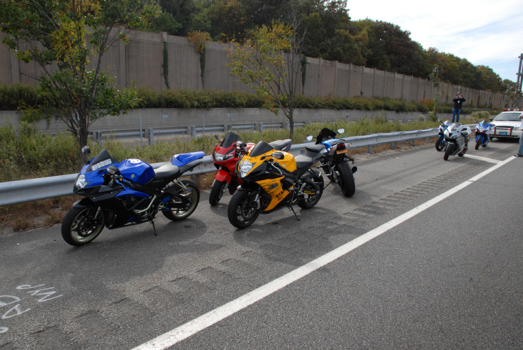 Image provided by police shows seven motorcyles lined up alongside the Long Island Parkway. Police impounded the bikes after charging their riders with reckless driving and other offenses.