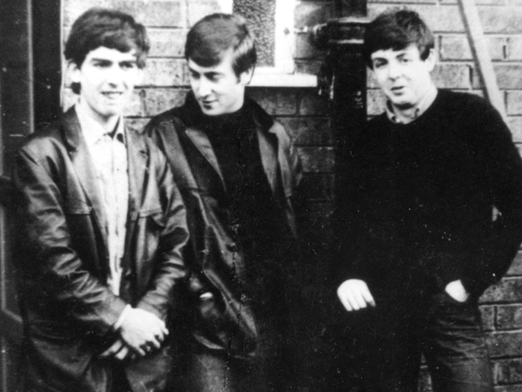 circa 1960:  Liverpudlian skiffle beat band The Beatles standing outside Paul's Liverpool home (left to right) George Harrison (1943 - 2001), John Len...
