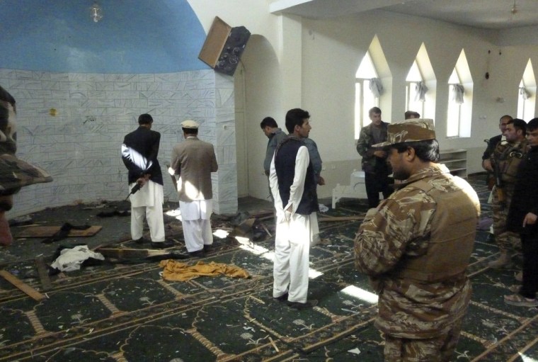 Police and officials examine the mosque in Puli Alam, Logar Province, Afghanistan, where a bomb hidden in the base of a microphone killed Governor Arsallah Jamal, Tuesday.