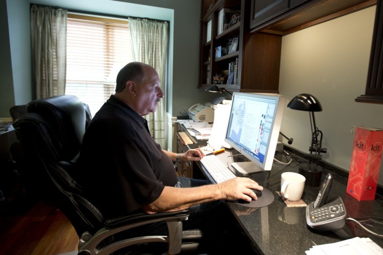 In this Wednesday, Oct. 9, 2013 photo, graphic designer Tom Sadowski, 65, who delayed his retirement, works from home in Sterling, Va.