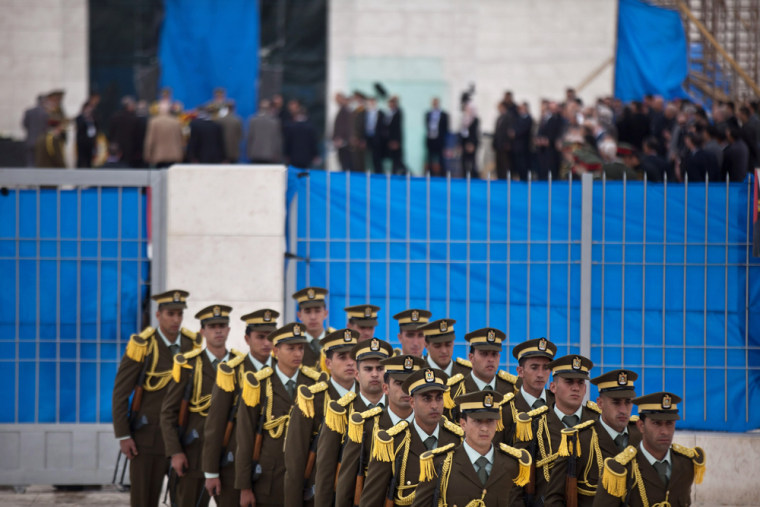 Members of an honor guard leave the mausoleum of Yasser Arafat after a ceremony on November 27, 2012 in Ramallah, West Bank after investigators exhumed and reburied the body of former Palestinian leader Yasser Arafat.