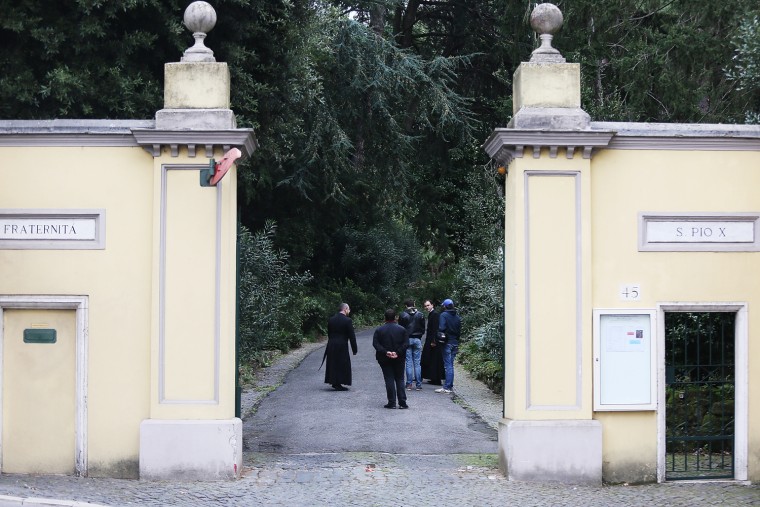 People gather outside the church of Lefebvriani, in Albano Laziale, on Tuesday, where the funeral of Erich Priebke took place.