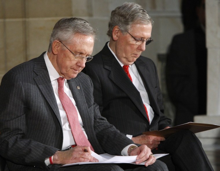 U.S. Senate Majority Leader Harry Reid, left, and Senate Minority Leader Mitch McConnell, right, look at their notes during a ceremony for the 50th anniversary of the March on Washington for Jobs and Freedom at the U.S. Capitol in Washington, in July.