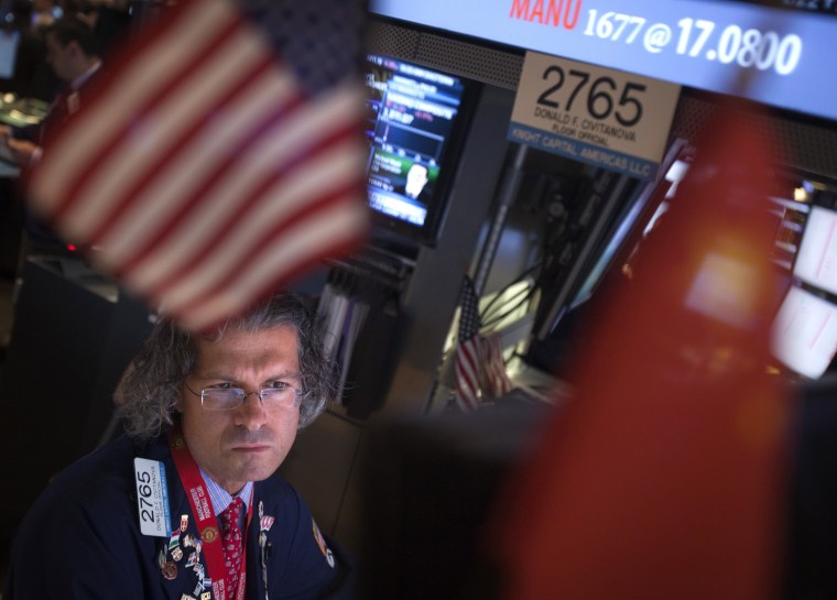 A trader looks at his screen on the floor of the New York Stock Exchange at the market open in New York on Tuesday, Oct. 15, 2013.