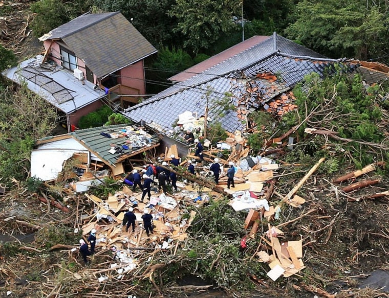 An aerial view shows rescue workers searching among collapsed houses following a landslide caused by Typhoon Wipha on Izu Oshima island, south of Tokyo, on Oct. 16.
