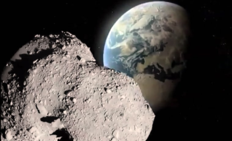 Screen shot from Los Alamos National Laboratory video shows a simulation of a large asteroid in the foreground, with Earth in the rear.