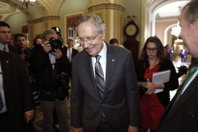 Senate Majority Leader Harry Reid (D-NV) returns to the Senate floor, declining to speak with reporters after a Senate Democratic caucus luncheon at the U.S. Capitol in Washington, October 15, 2013.