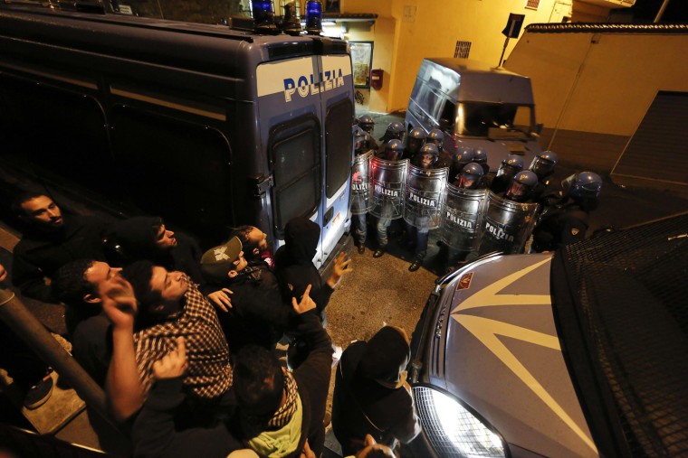 The van with Erich Priebke's coffin leaves from a building in Albano on Tuesday, en route to the military airport.