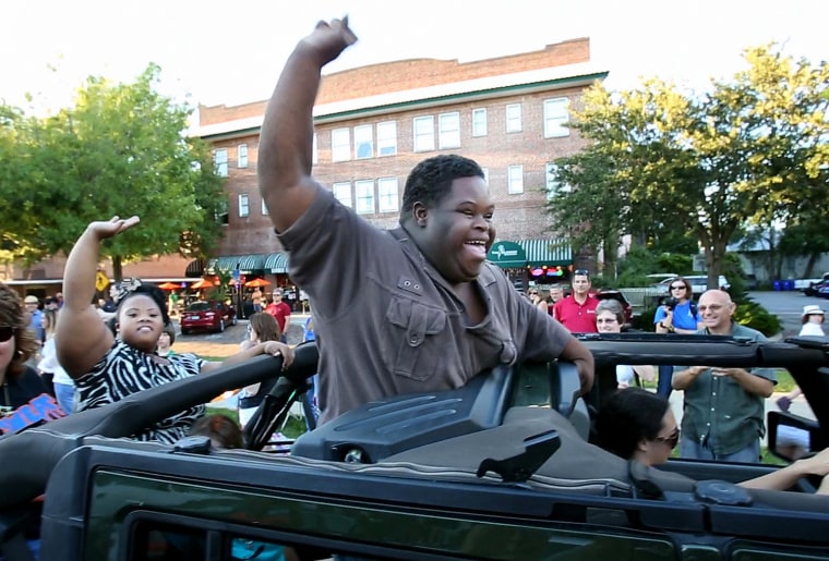 Bubba Hunter, right, and Semone Adkins, both homecoming king candidates for West Orange High, are the stars of the homecoming parade in downtown Winte...