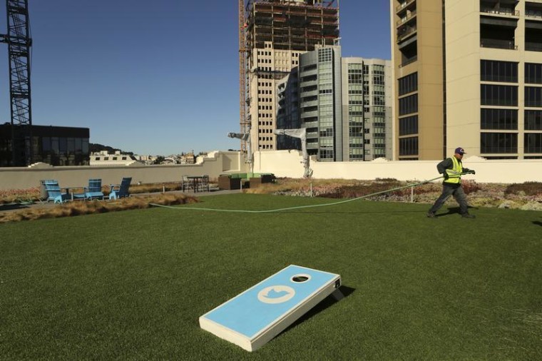 A worker tends to the lawn on the roof of Twitter headquarters in San Francisco in this Oct. 4 photo. As Twitter prepares for its IPO, some investors are nervous about its outlook.