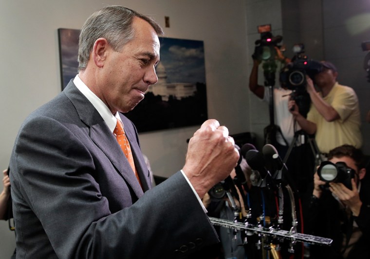 Speaker of the House John Boehner (R-OH) pumps his fist after leaving a meeting of House Republicans at the U.S. Capitol October 16, 2013 in Washington, DC.