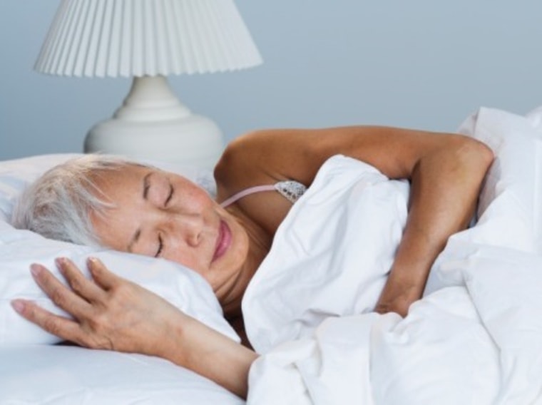 Senior Asian woman sleeping in bed. People, Bed, Horizontal, Indoors, High Angle View, Front View, Head And Shoulders, Asian Ethnicity, Bedroom, Lying...