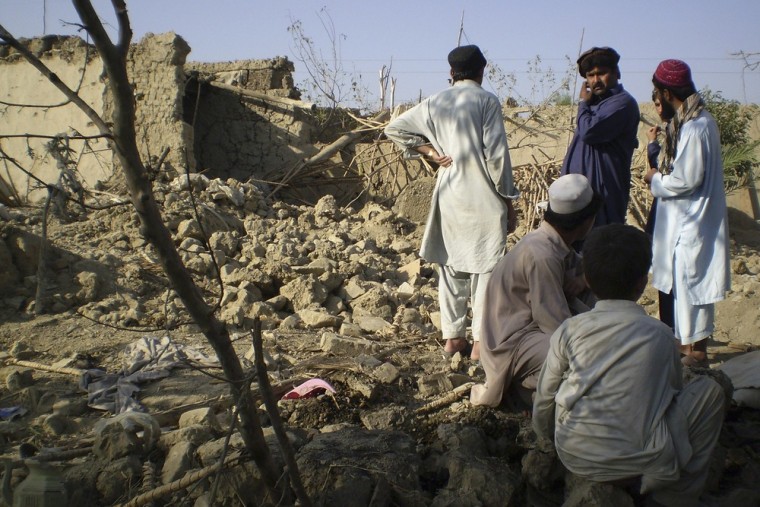 Tribesmen gather at a site of a missile attack on the outskirts of Miranshah, near the Afghan border, October 12, 2008. Suspected U.S. drones fired two missiles into a Pakistani region regarded as a safe haven for al Qaeda and Taliban militants, killing at least five insurgents, residents and an intelligence official said.