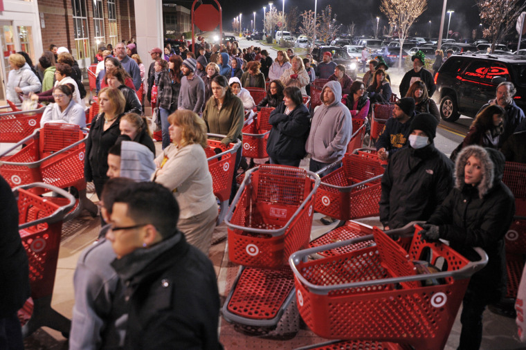 Shoppers wait outside the Target store in Lisbon, Conn., before the store opens for Black Friday in this 2011 file photo. The end of the government shutdown could mean more deals for consumers.