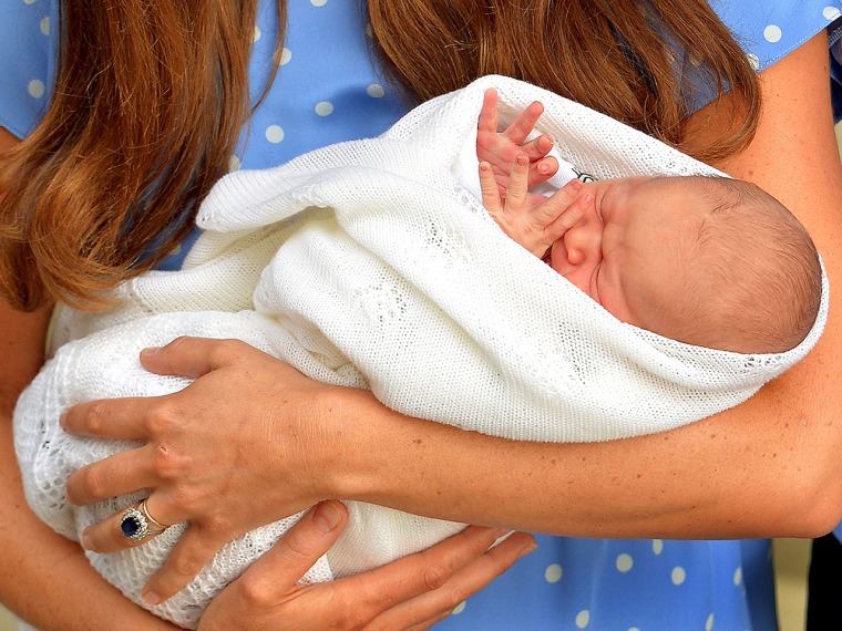 Image: Prince George in his mother's arms