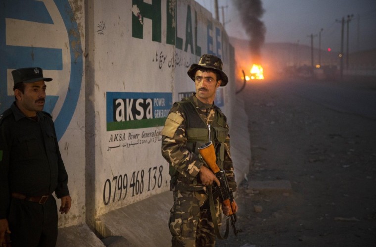 Afghan police secure the area after a car bomb detonated outside an ISAF civilian personnel compound in Kabul, Afghanistan, Friday.