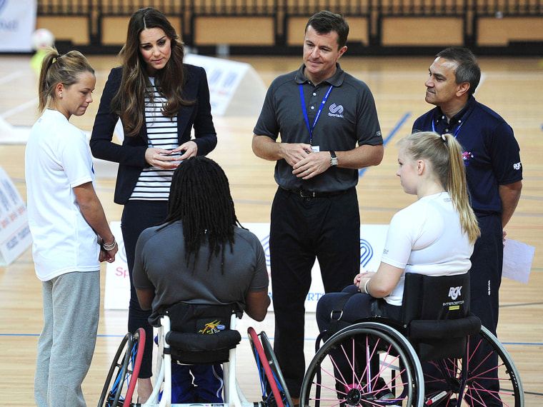 Britain's Catherine, Duchess of Cambridge (2-L) speaks with athletes during a trip to the SportsAid Athlete Workshop in the Copper Box at the Queen El...