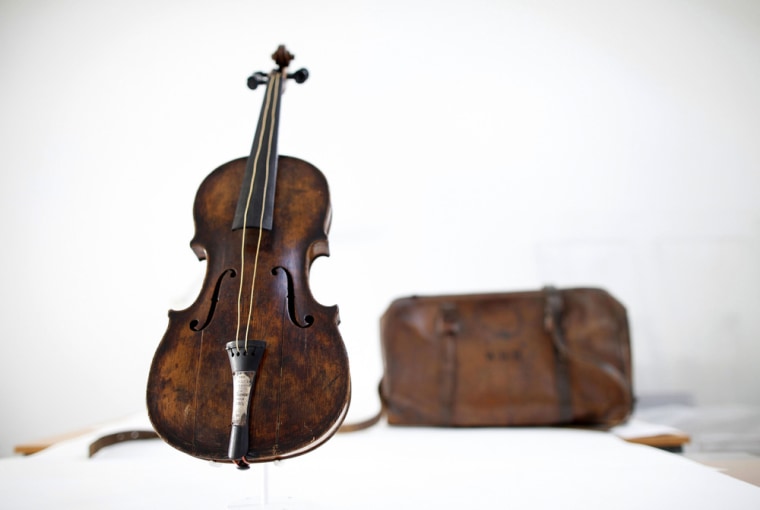 The violin above was played by bandmaster Wallace Hartley during the final moments before the sinking of the Titanic. Next to it sits a leather carrying case initialed W H H.