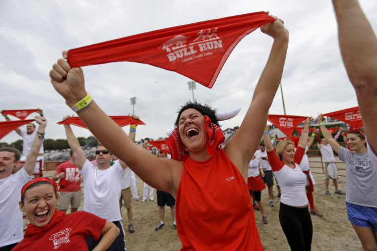 Megan Wright, right, and Jennifer Campbell, left, both of Mobile, Ala., chant with the crowd before running alongside charging bulls during the Great Bull Run at the Georgia International Horse Park, on Oct. 19, in Conyers, Ga.