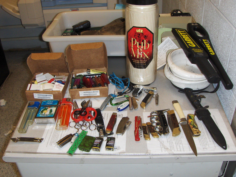 A handout image of the knives, scissors and lighters that police say were found in the carry-on bag of a passenger at JFK.