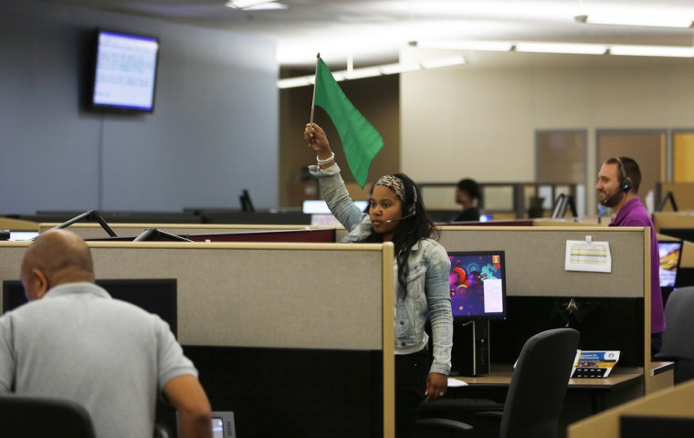 A customer service agent at Covered California's Concord call center waves a flag for technical assistance during the opening day of enrollment of the...
