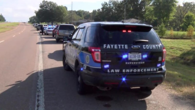 Emergency responders along the road near where a medical helicopter crashed Tuesday in Tennessee, killing all three on the crew.