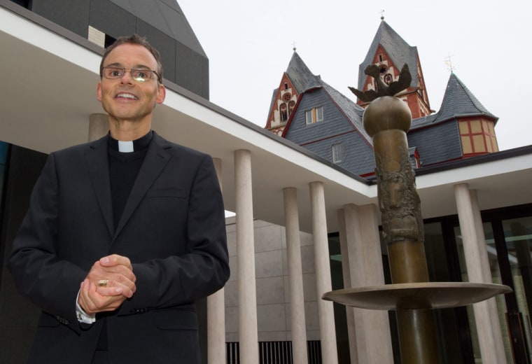 A file photo shows Franz-Peter Tebartz-van Elst, the bishop of Limburg, posing for photographs in the inner courtyard of the bishop's residence opposite the cathedral in Limburg, Germany.