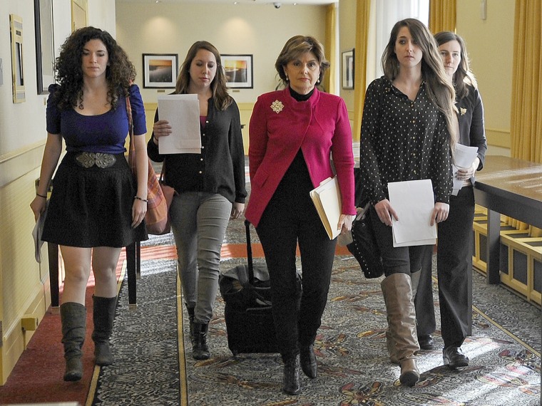 Attorney Gloria Allred, center, walks with current and former University of Connecticut students, from left, Rose Richi, left, Erica Daniels, Carolyn Luby and Kylie Angell to a news conference Monday in Hartford, Conn. The four women, who say they were victims of sexual assaults while students at the school, have announced they are filing a federal discrimination lawsuit against the university.