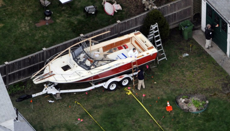 Investigators work around the boat where Dzhokhar Tsarnaev was found hiding after a massive manhunt, in the backyard of a Watertown, Mass., Street home, in an aerial photo taken on April 20.