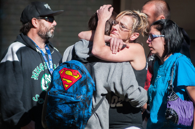 A student at Sparks Middle School in Nevada, with his back to the camera, cries with family members after a shooting on Monday. Despite intense publicity, such events remain rare.