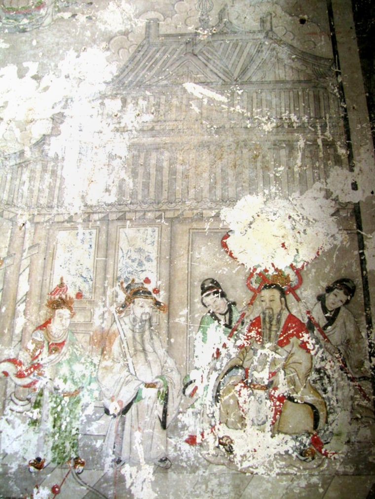 This picture taken on April 3, 2011 shows one of the ancient frescos that are currently covered by cartoon-like paintings in Yunjie Temple in Chaoyang, northeast China's Liaoning province.