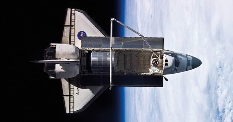 The bay doors of the shuttle Discovery are open wide just after leaving from the International Space Station in April 2010.