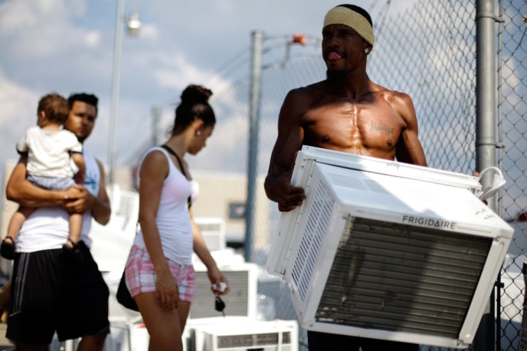 Image of Salesman Lu Pichardo with an air conditioner