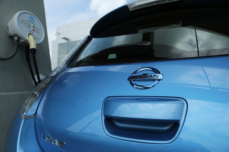 A Nissan Leaf full electric car is seen at a charging station at Darcars Nissan in Rockville, Md. Governors of eight states have pledged to get more electric and other zero-emission vehicles on the roads.